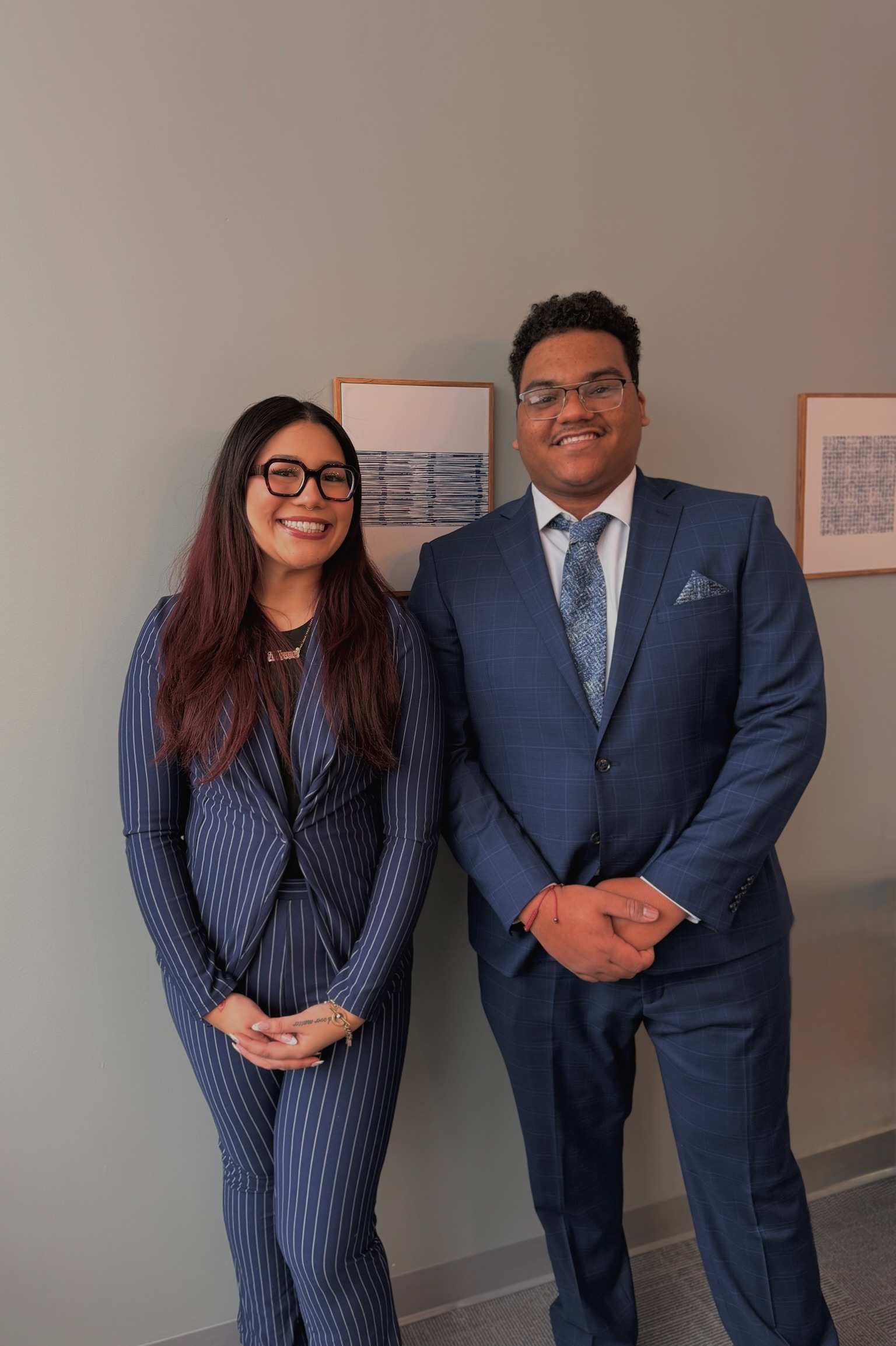 Two Skyline Consulting professionals posing in coordinated blue business attire