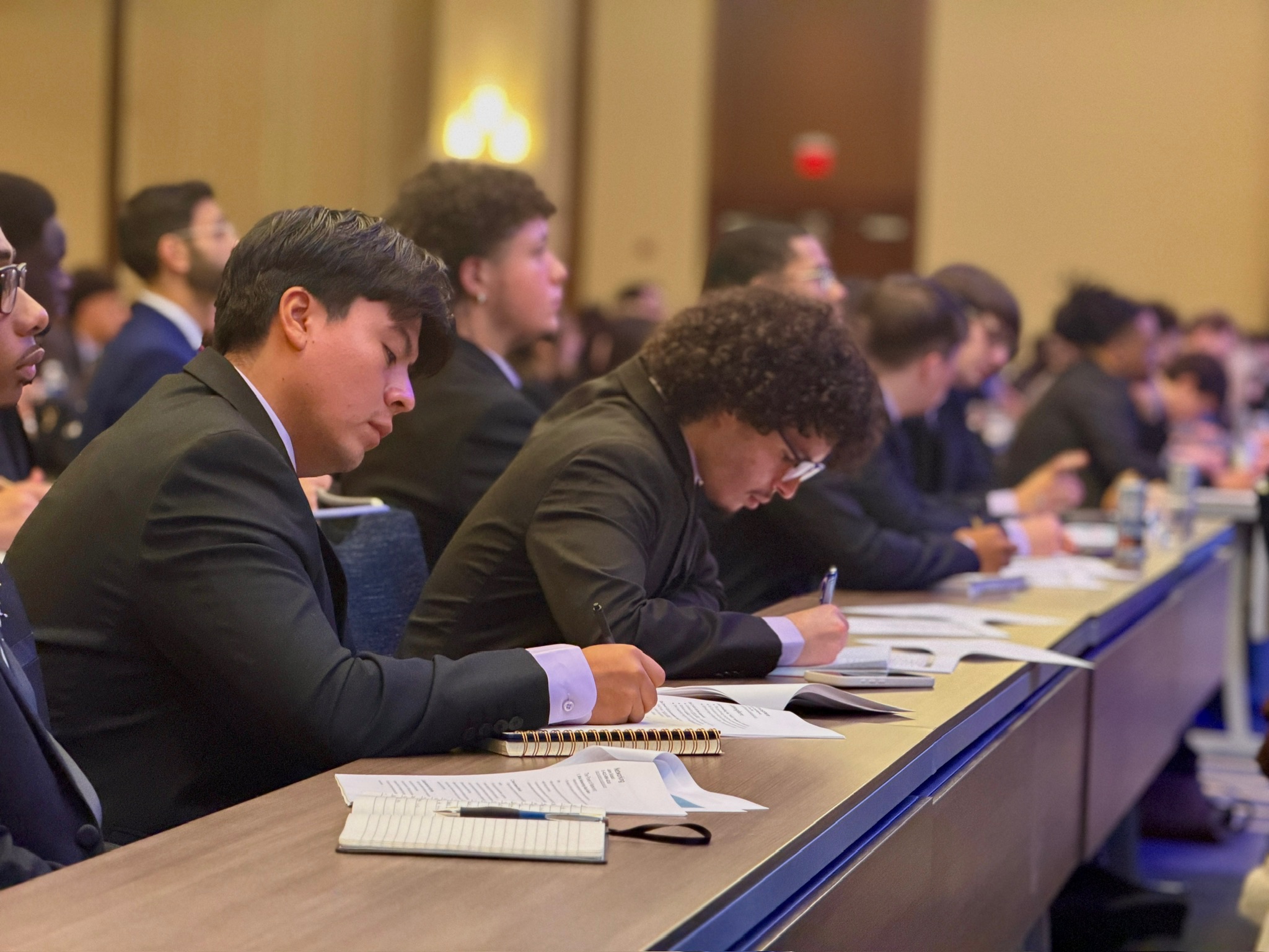 Skyline Consulting members taking notes during a professional conference session